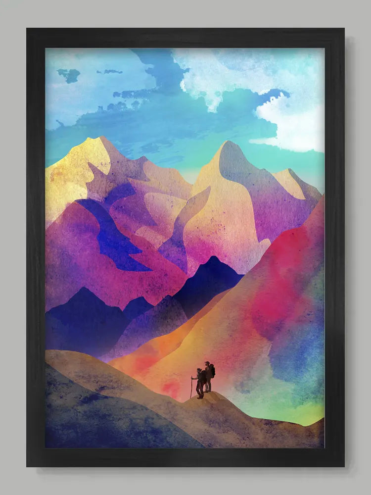Framed artwork of a colorful mountain landscape with a silhouette of a person on a hill.