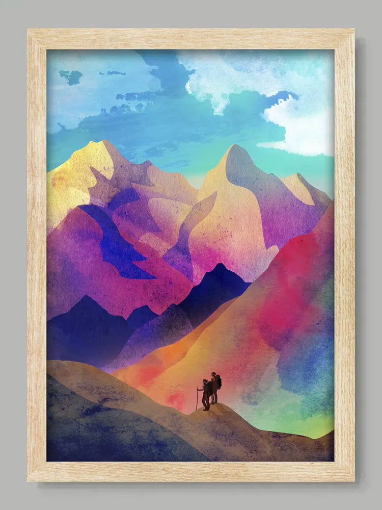 Framed artwork of a colorful mountain landscape with a silhouette of a person on a bike.