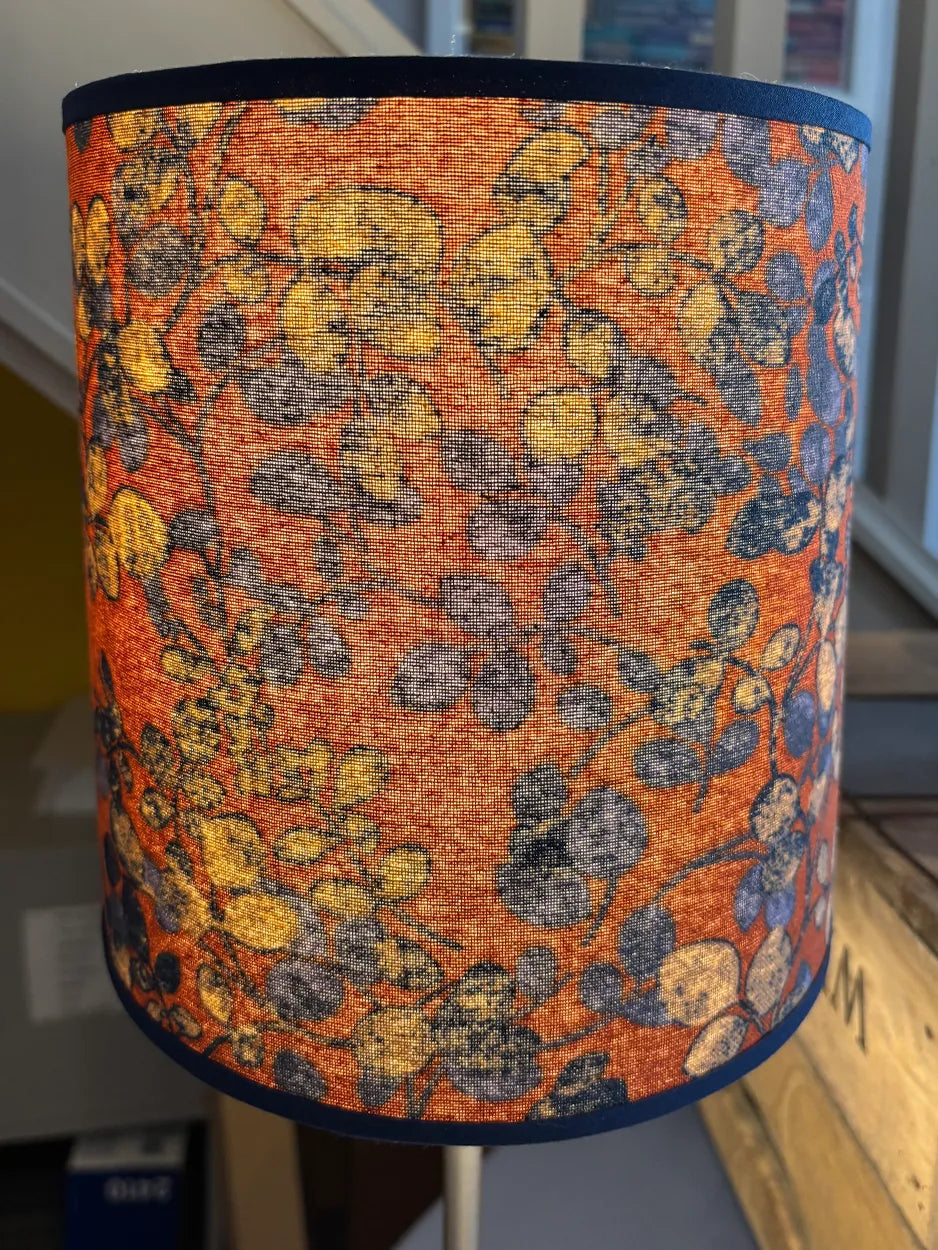 This beautiful handmade lampshade is covered in a fabulous blue and soft orange Liberty fabric. It will make a stunning design statement in any room.
