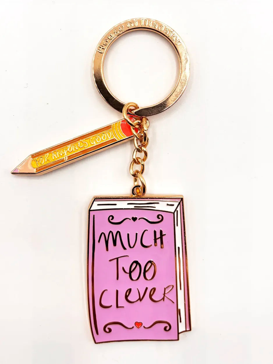 This cute metal keyring is finished in enamel. It features the slogan 'Much Too Clever'