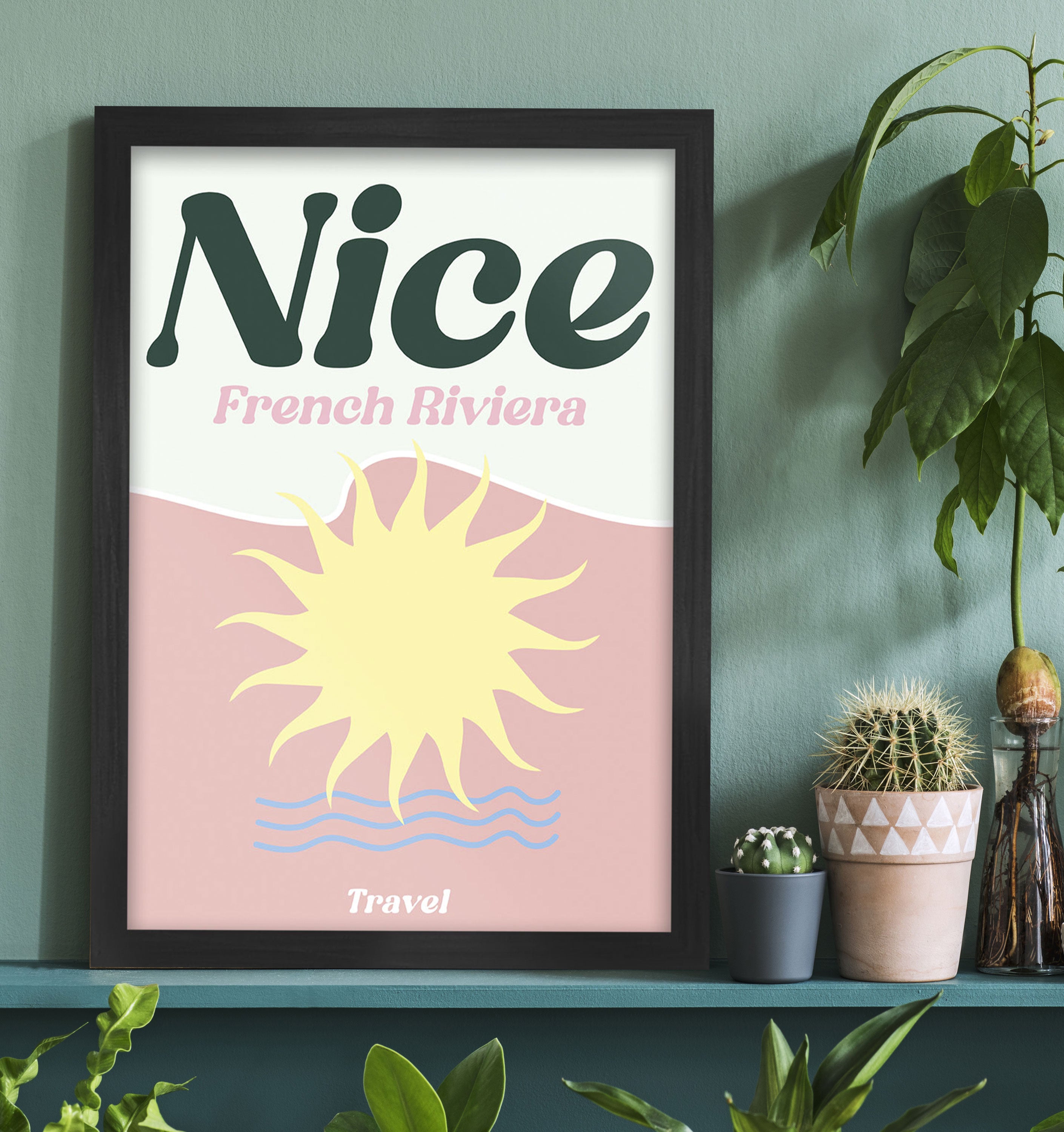 Framed poster with 'Nice French Riviera' design on a shelf with plants