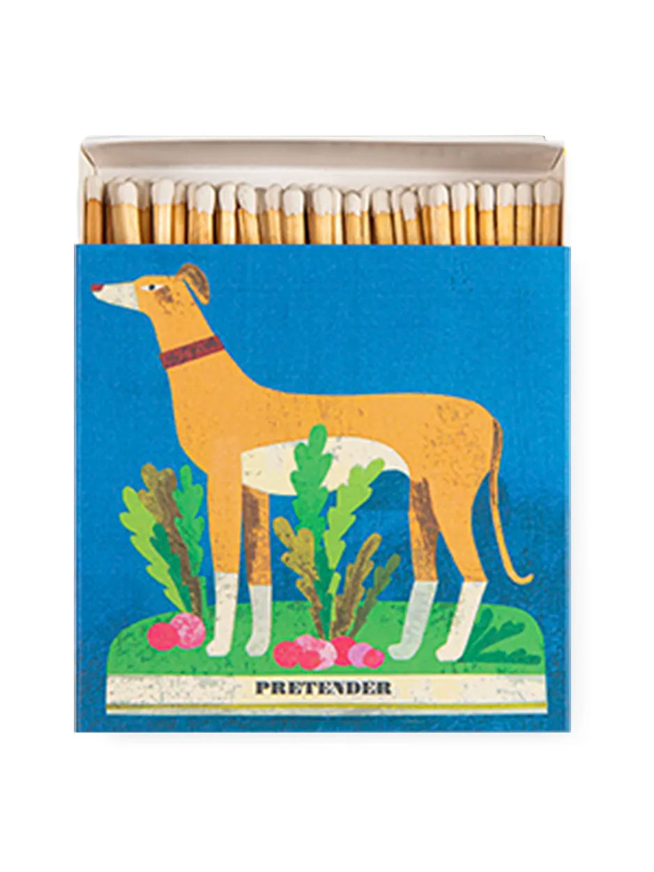 Square matchbox featuring a whippet standing amongst the radishes on a bold blue background. Designed by Marion Elliot. Striking in every sense – these matchboxes are filled with 125 matchsticks ready to spark a little joy. Designed to add character to coffee tables, mantelpieces, and gift drawers, each box is a blend of function and flair.