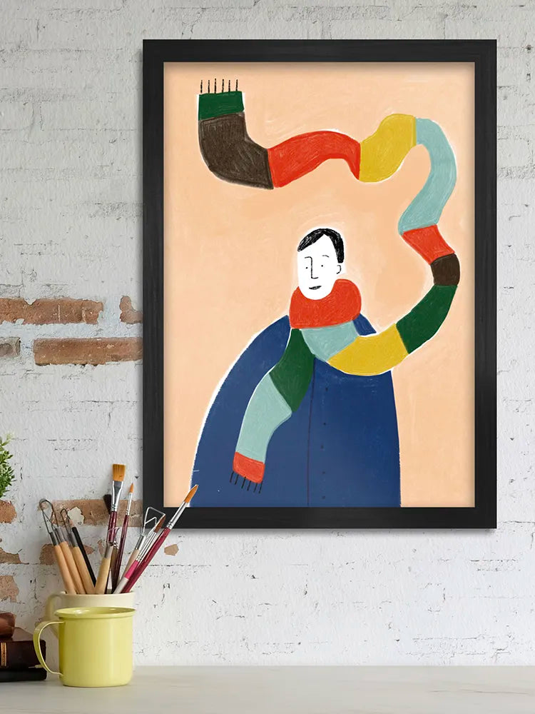 Framed abstract artwork of a person with colorful scarf on a white brick wall.
